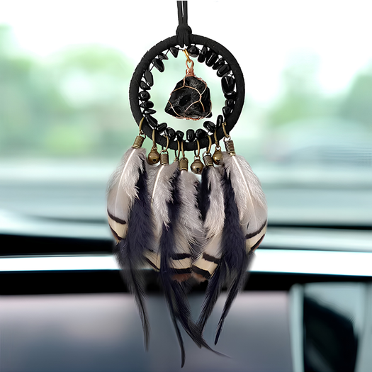 The Journey Guardian dreamcatcher hanging from a car rearview mirror
