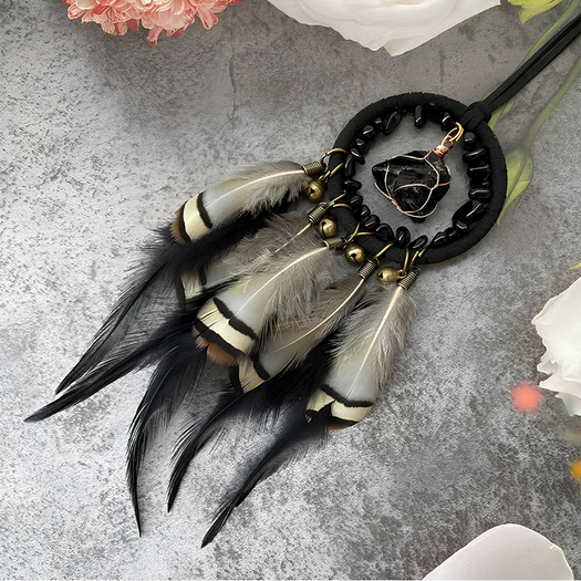 Close-up flat lay of the Journey Guardian dreamcatcher with flowers