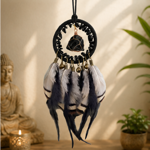 The Journey Guardian dreamcatcher hanging near a Buddha statue and candles